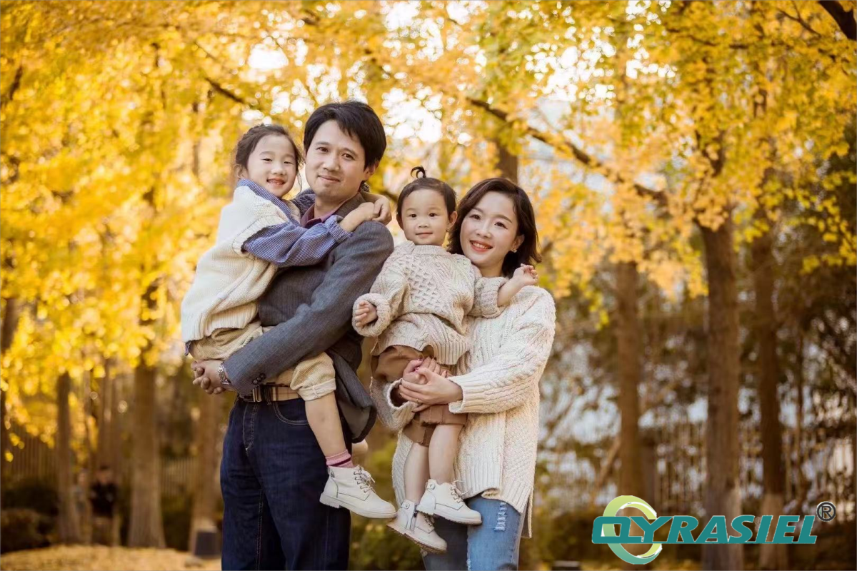 QYRASIEL founder with family in a warm autumn setting, symbolizing trust and dedication