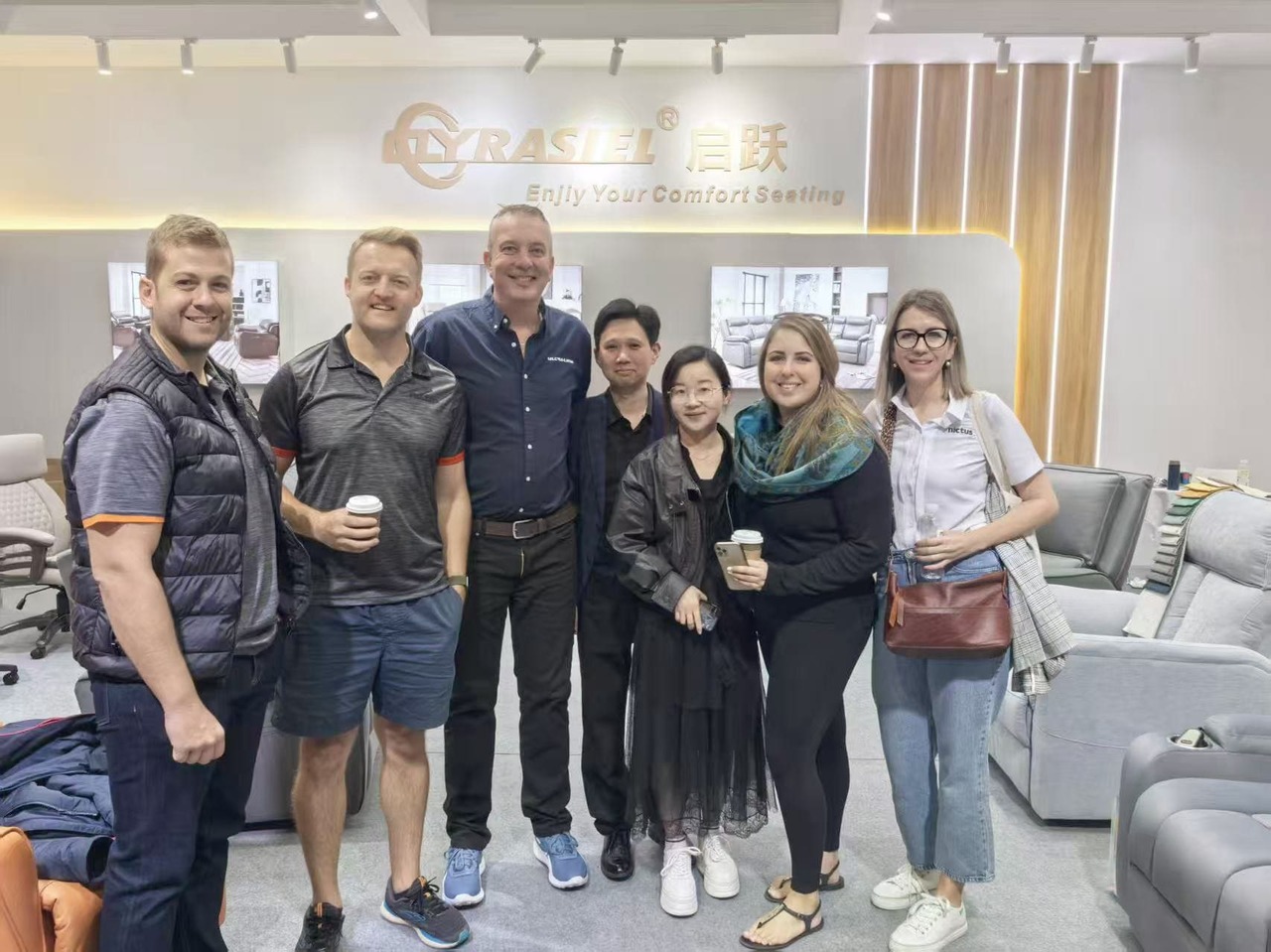 QYRASIEL team with international buyers at showroom