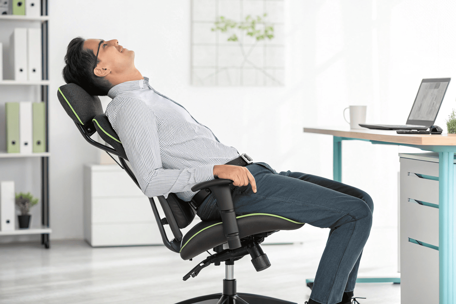 Man leaning back in ergonomic office chair