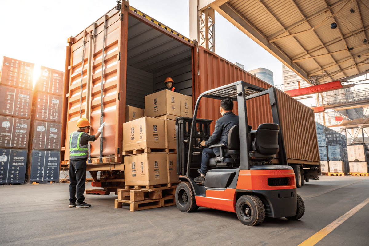 Forklift loading office chairs into container