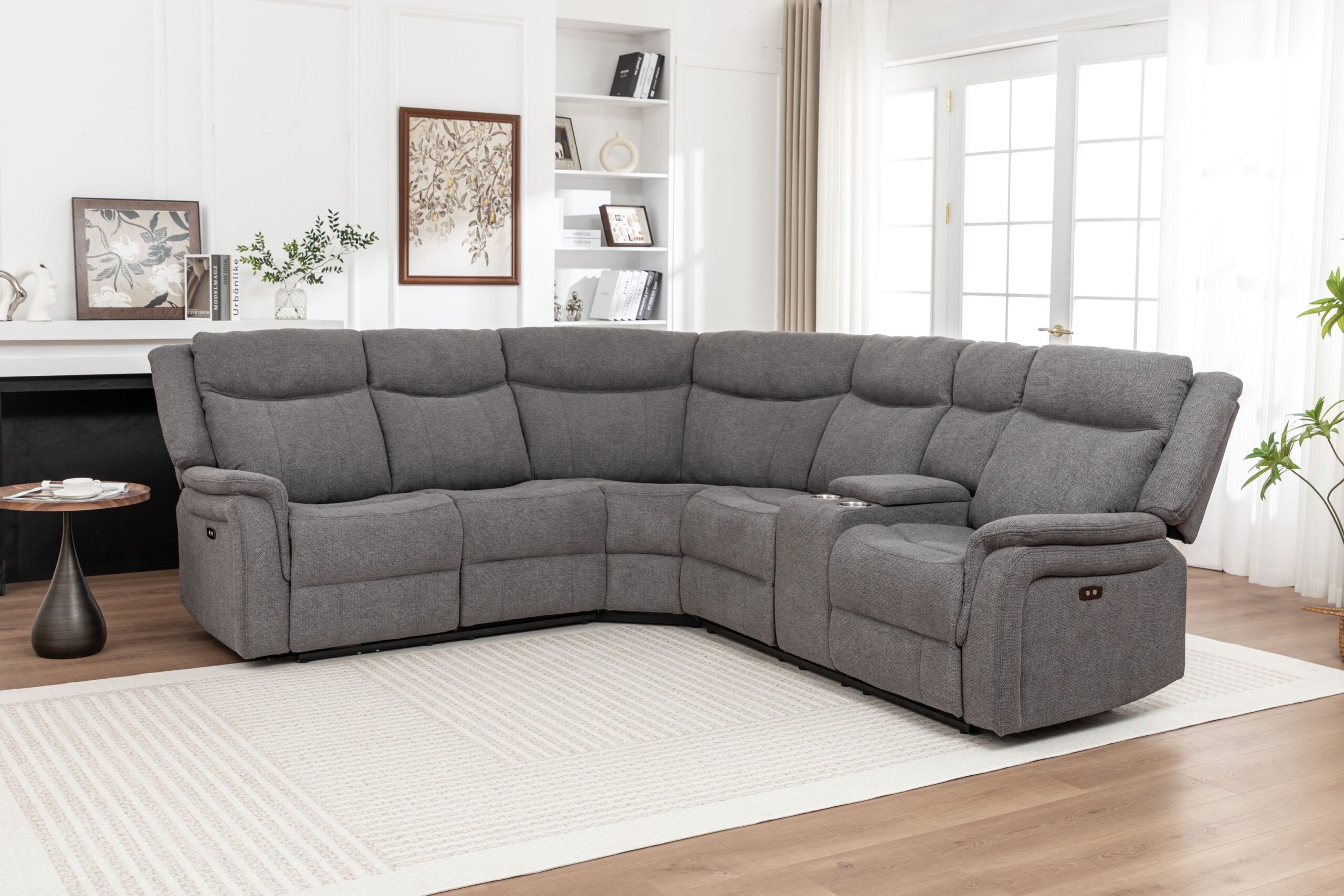 Large gray fabric sectional recliner in bright room